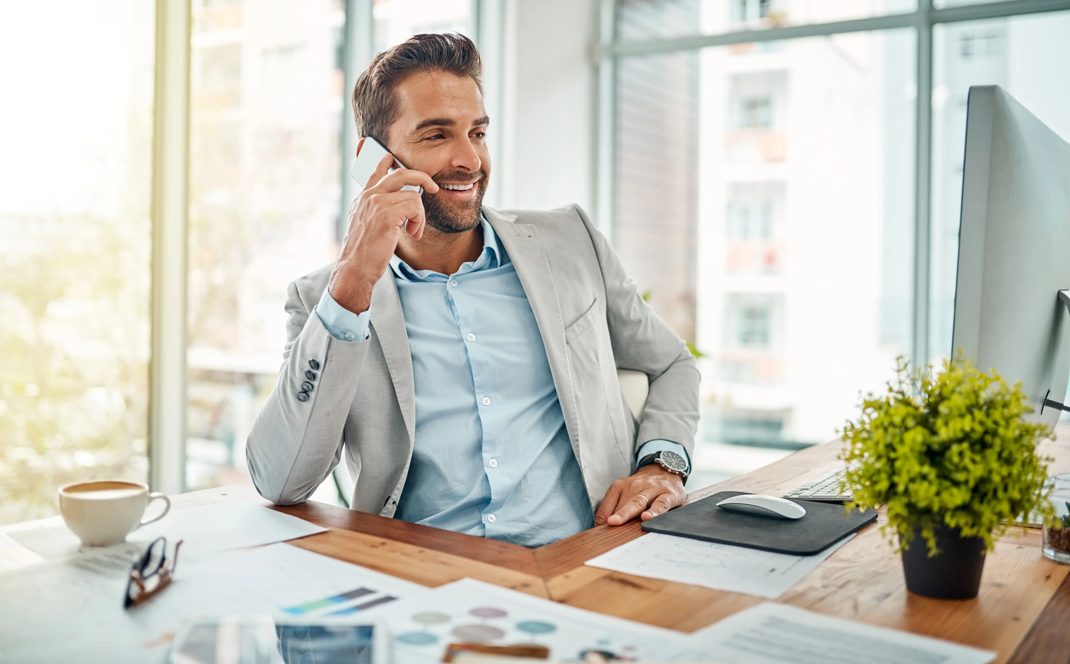 Young business professional having phone conversation in modern office setting